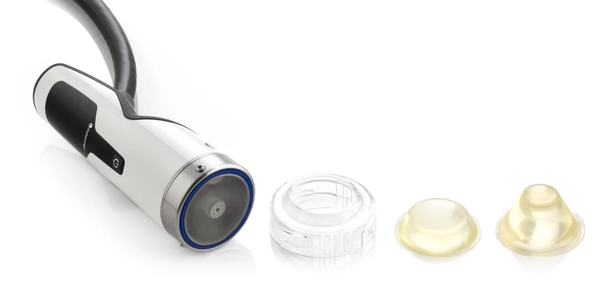Focused shockwave handpiece beside separate stand-off components